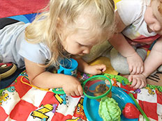 2-Year-Old Room - girl with magnifying glass
