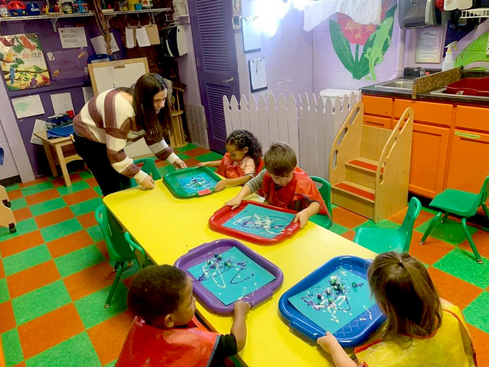 2-Year-Old Room - 2-year-old painting at Robins Nest Learning Center