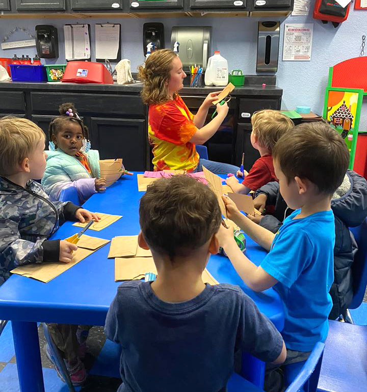 Children crafting with teacher at Robin's Nest Learning Center in Carbondale, Illinois