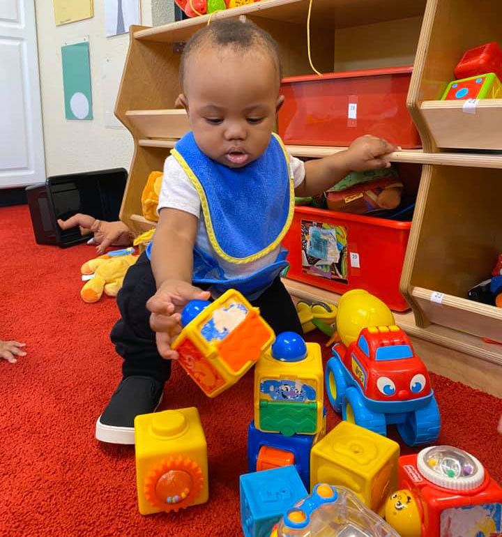 Infant playing with blocks at Robin's Nest Learning Center in Carbondale, Illinois