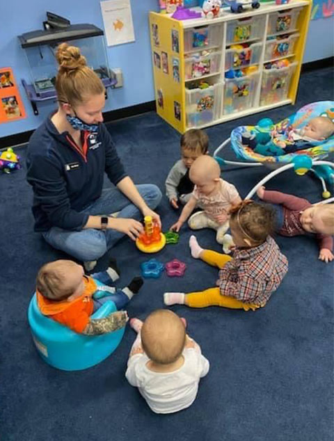 Teacher playing with babies at Robins Nest Learning Center at Robins Nest Learning Center