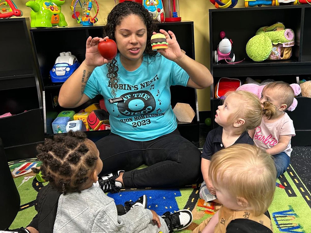 The Brown Bear Room - Babies playing with balls at Robins Nest Learning Center