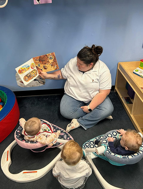 Infant playing with pinguins at Robins Nest Learning Center at Robins Nest Learning Center