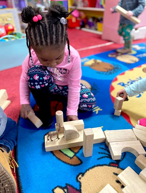 PreSchool - Girl playing with blocks at Robins Nest Learning Center