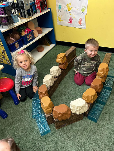 PreSchool - Teacher cards with students at Robins Nest Learning Center