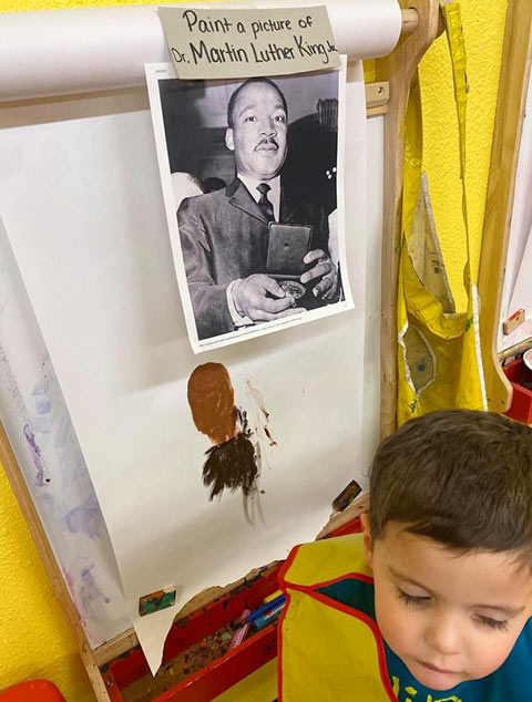 Pre-K Advanced - Student painting Dr. Martin Luther King at Robins Nest Learning Center