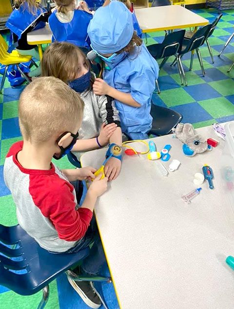 Pre-K Advanced - Kids playing doctor at Robins Nest Learning Center