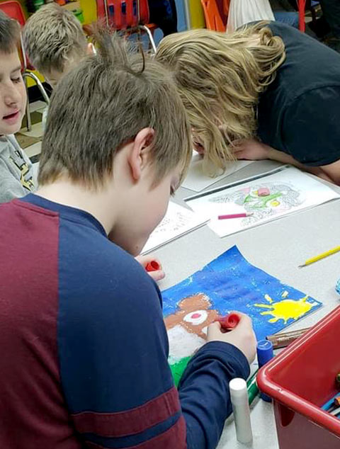 School-Aged - Students coloring at Robins Nest Learning Center