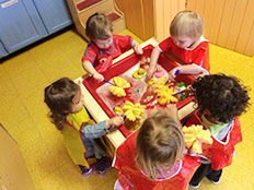 Toddlers Room - Kids washing dishes Robins Nest Learning Center